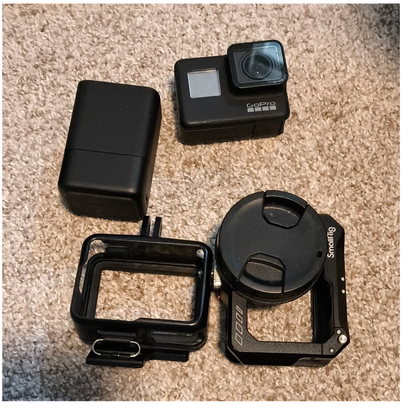 Black GoPro action camera accessory set with battery, protective housing, and mounts
