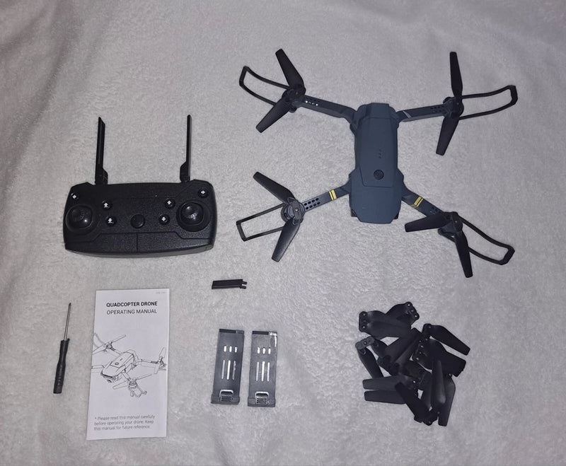 Quadcopter drone kit with controller, spare blades, batteries and manual