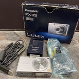Silver Panasonic LUMIX FX35 compact camera with lens, box, USB cable, battery