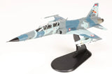 Blue and gray F-5F Tiger II fighter jet scale model on black display stand