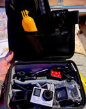 Open black action camera case with HERO4 camera, battery, charger, mounts