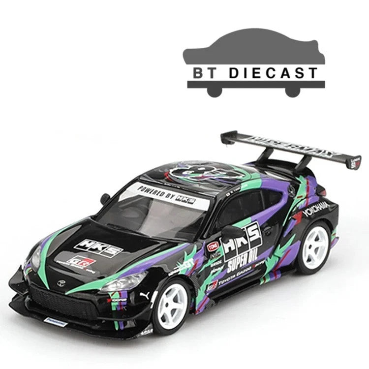 Die-cast sports car in black with green and purple decals, white wheels, rear wing