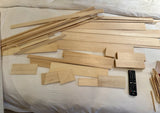 Assorted balsa wood strips and blocks, light tan rectangular pieces for model making