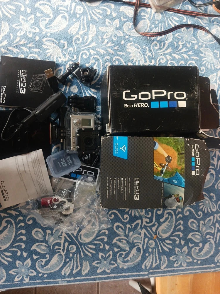 GoPro HERO3 Black waterproof action camera with front lens and included accessories