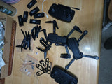 Used E88–E99 PRO drone parts lot with multiple black frames, arms, and propeller mounts