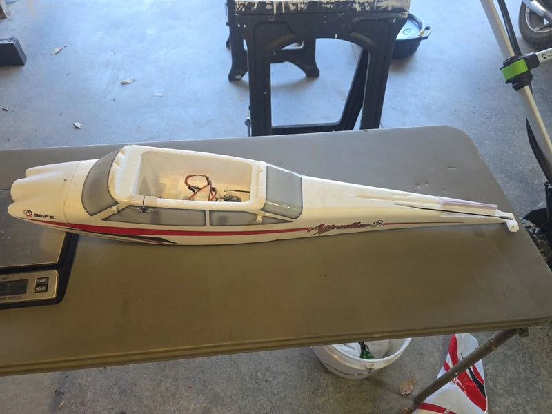 Yellow electric airplane fuselage with open cockpit and wing, sold for parts