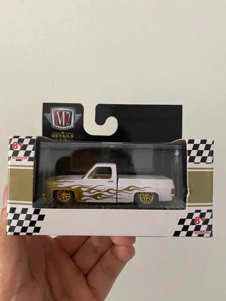 1:64 toy pickup truck car model in box, silver with flame decals and gold wheels