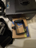 GoPro action camera in black case with accessories cards in retail packaging