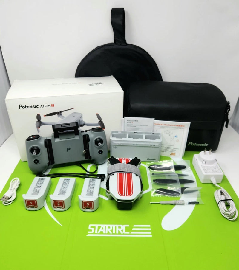 Drone kit with remote, batteries, propellers, manuals, and carry bag