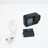 Black GoPro HERO13 action camera with front lens, small battery and white USB cable