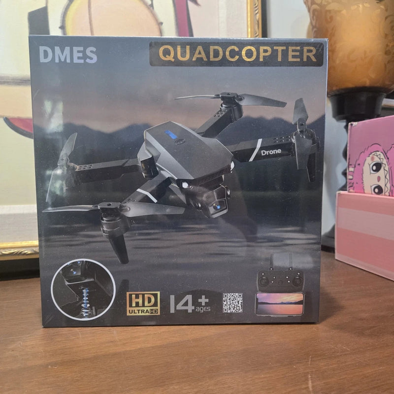 Black quadcopter drone with HD camera and optical flow, shown on product box