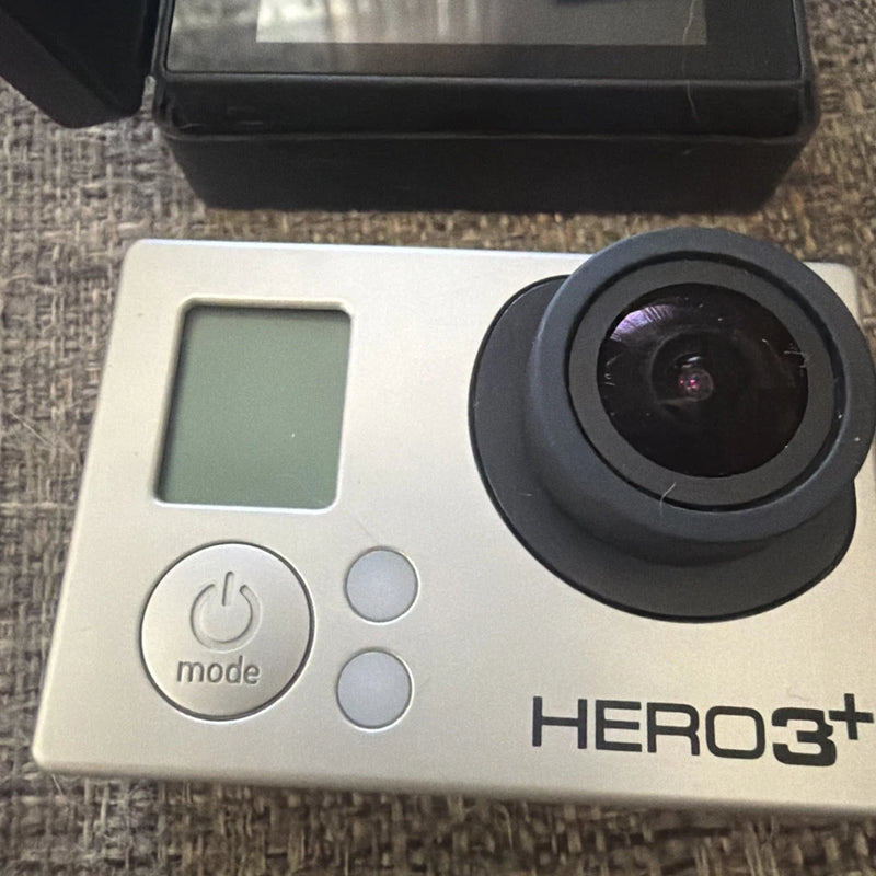 GoPro HERO3+ action camera with LCD screen, mode button, and lens front view