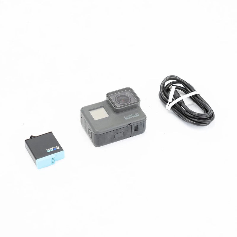 GoPro HERO6 action camera with lens and screen, plus cable and memory card