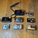 Vintage digital camera lot with multiple cameras and attached straps