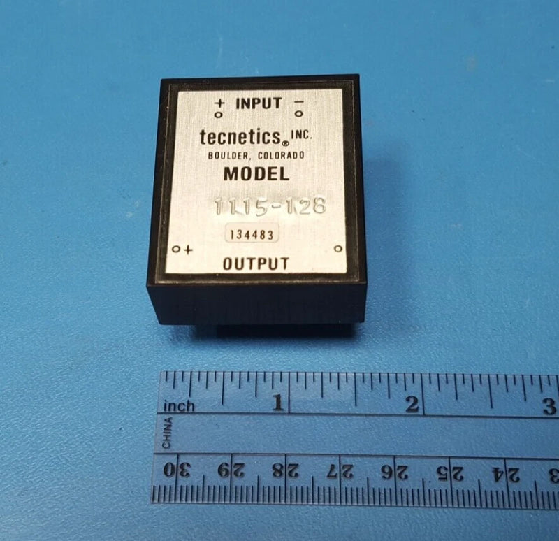 Tecnetics DC-DC converter module with input/output label on black rectangular housing