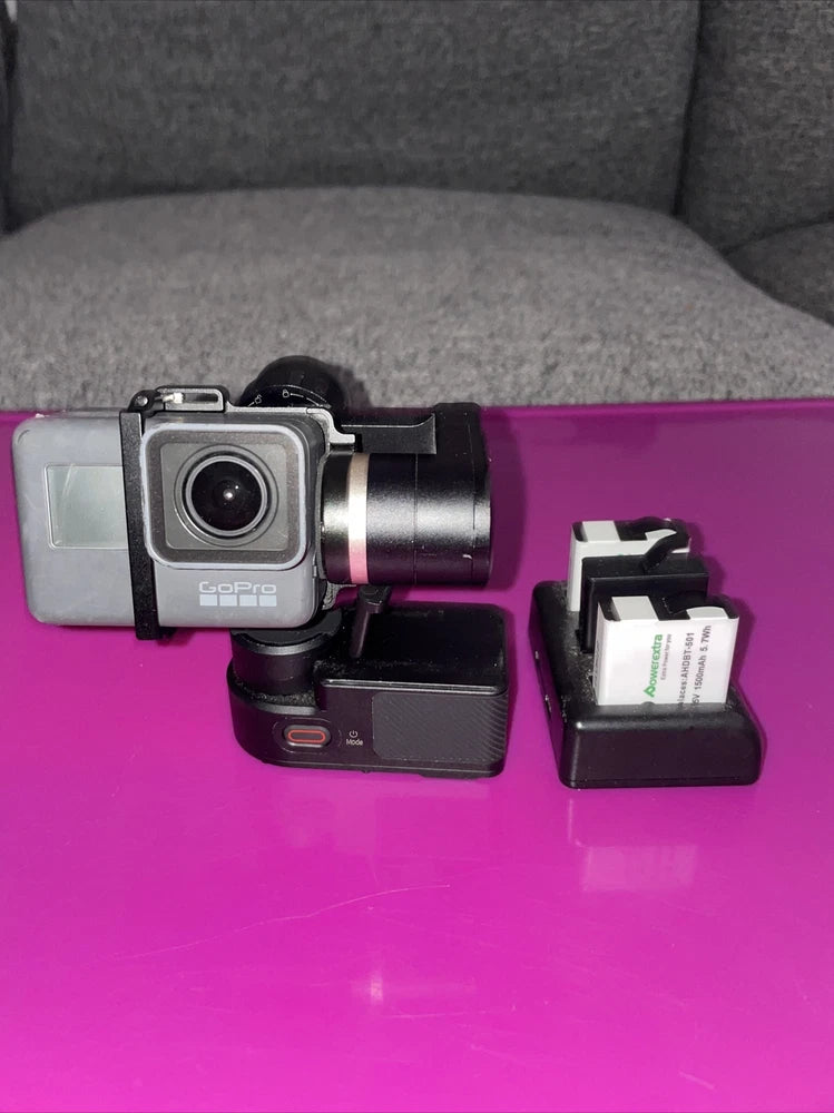 GoPro HERO5 action camera with black housing and lens, mounted on purple stabilizer