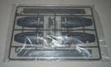 Model aircraft parts sprue with dark engine nacelles and stabilizer flap pieces on frame