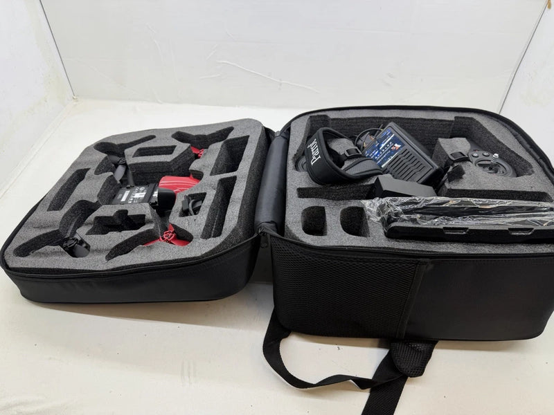 RC drone kit with controller in black foam-lined carrying case
