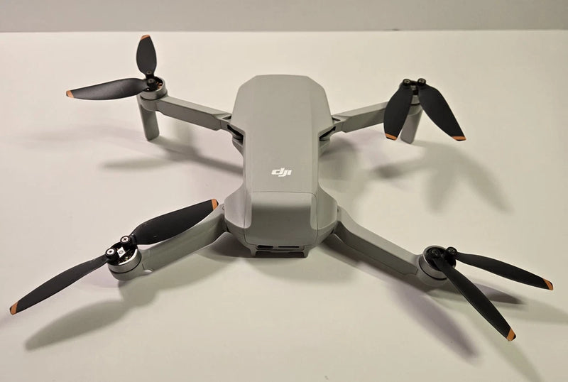 DJI Mini 2 quadcopter drone with four gray arms and black propellers