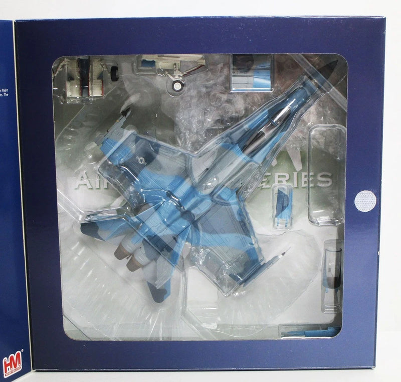 Blue and gray F/A-18A model aircraft in clear blister packaging