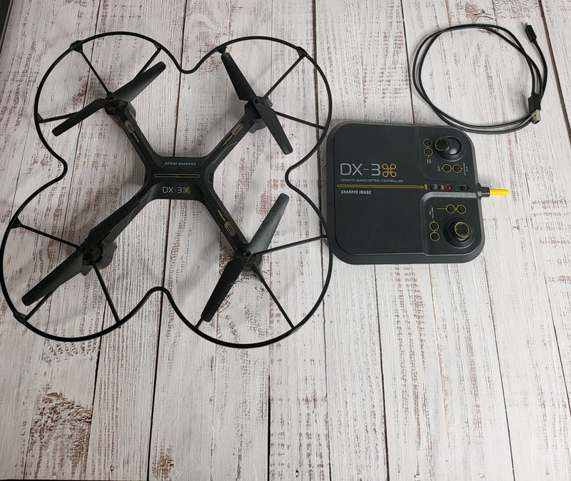 Black video drone with four propellers and matching black remote controller