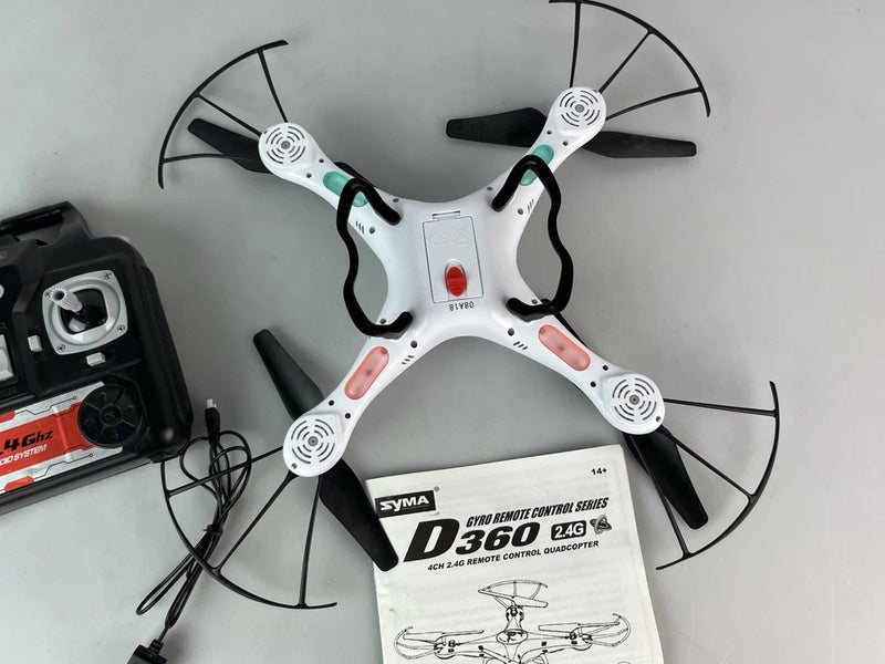 White quadcopter drone with four propellers, black accents, and D360 control box
