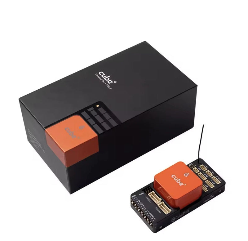 Cube+ flight controller module with orange top and electronic circuit board