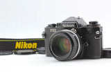 Nikon FE2 black 35mm film camera with attached lens and neck strap