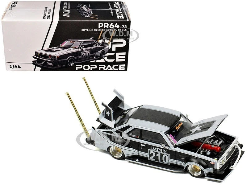 Matte black and silver die-cast model car with open hood, number 210, front 3/4 view.