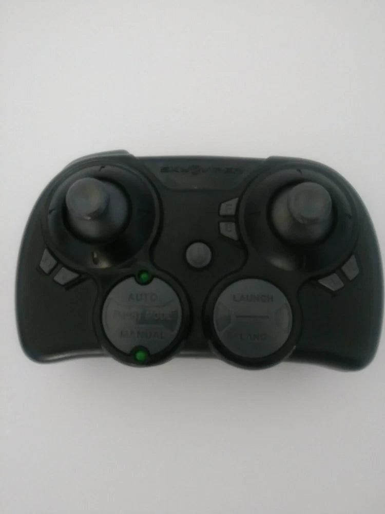 Black handheld remote controller with two thumbsticks and AUTO/LAUNCH buttons.