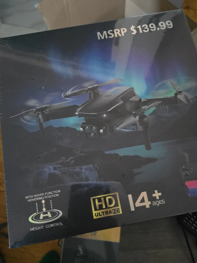 Folding drone product box showing compact quadcopter with HD Ultra HD and age 14