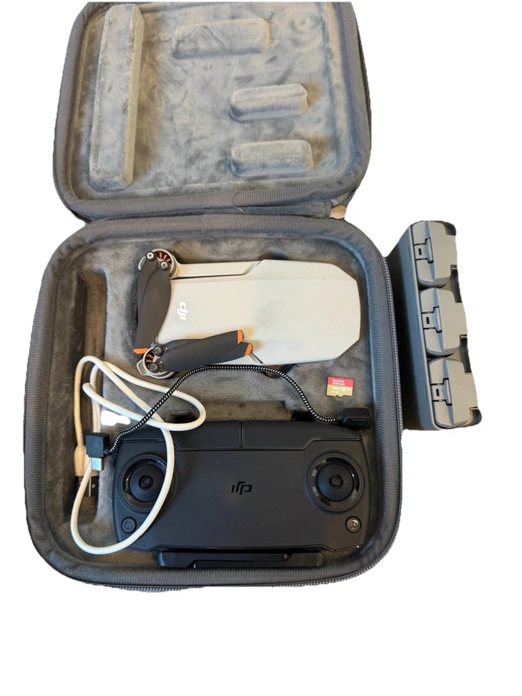 DJI Mini SE drone in soft zip case with controller, cables, and prop guard
