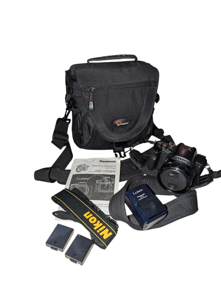 Black camera carry case with digital camera, batteries, and charger accessories