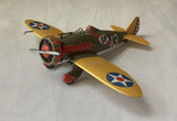 Toy model airplane with yellow wings, red nose, and propeller, U.S. Army style markings