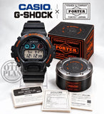 Black Casio G-Shock digital wristwatch with orange accents, shown with Porter box and papers