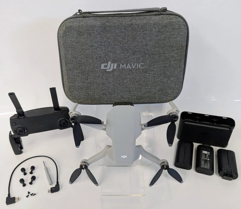 DJI Mavic Mini drone kit with gray carry case, controller, props, and batteries