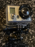GoPro HERO v1 action camera in clear waterproof case with black lens and HERO logo