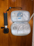 GoPro HERO4 action camera with open waterproof storage case and strap