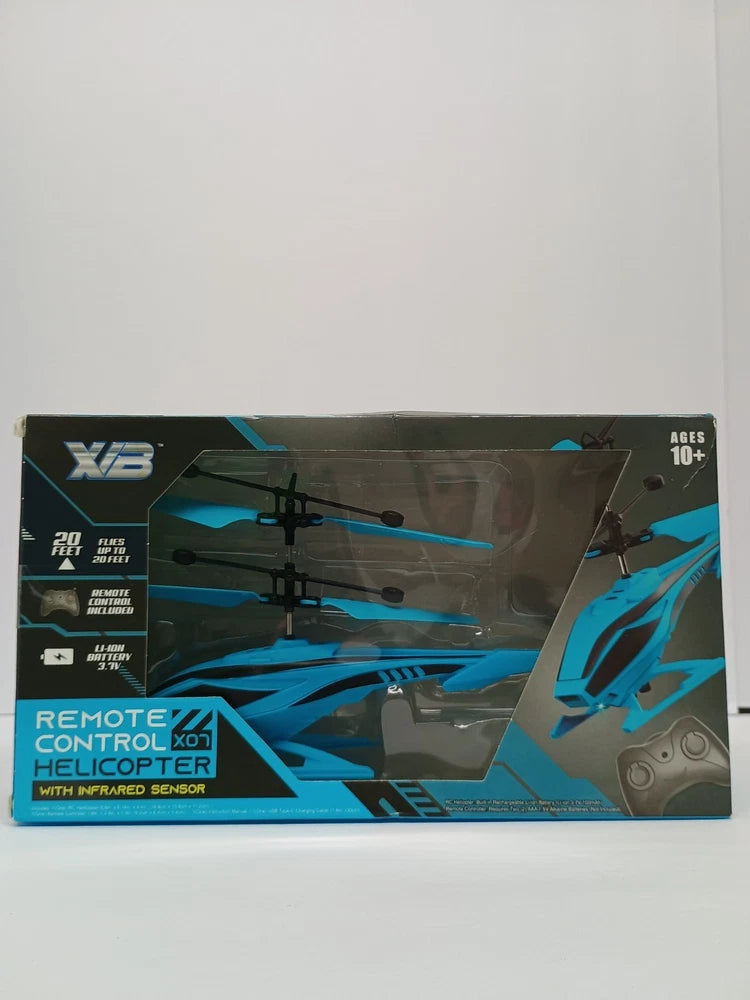 Remote control helicopter toy in blue retail box with controller and sensor window