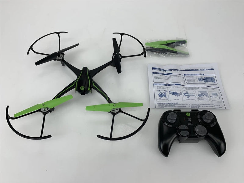 Green and black quadcopter drone with four propellers and black remote controller