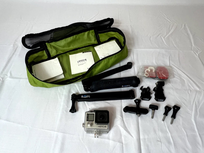 Silver action camera with green zip case and mounting accessories set, including mounts