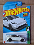Hot Wheels Tesla Model Y white toy car in blister pack, black wheels