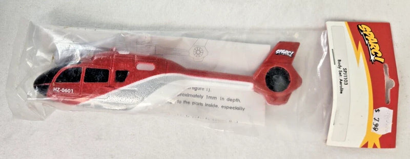Red model airplane body set in clear plastic packaging with instruction card