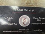 Printed card with Social Cabaret logo, business details, and contact information text