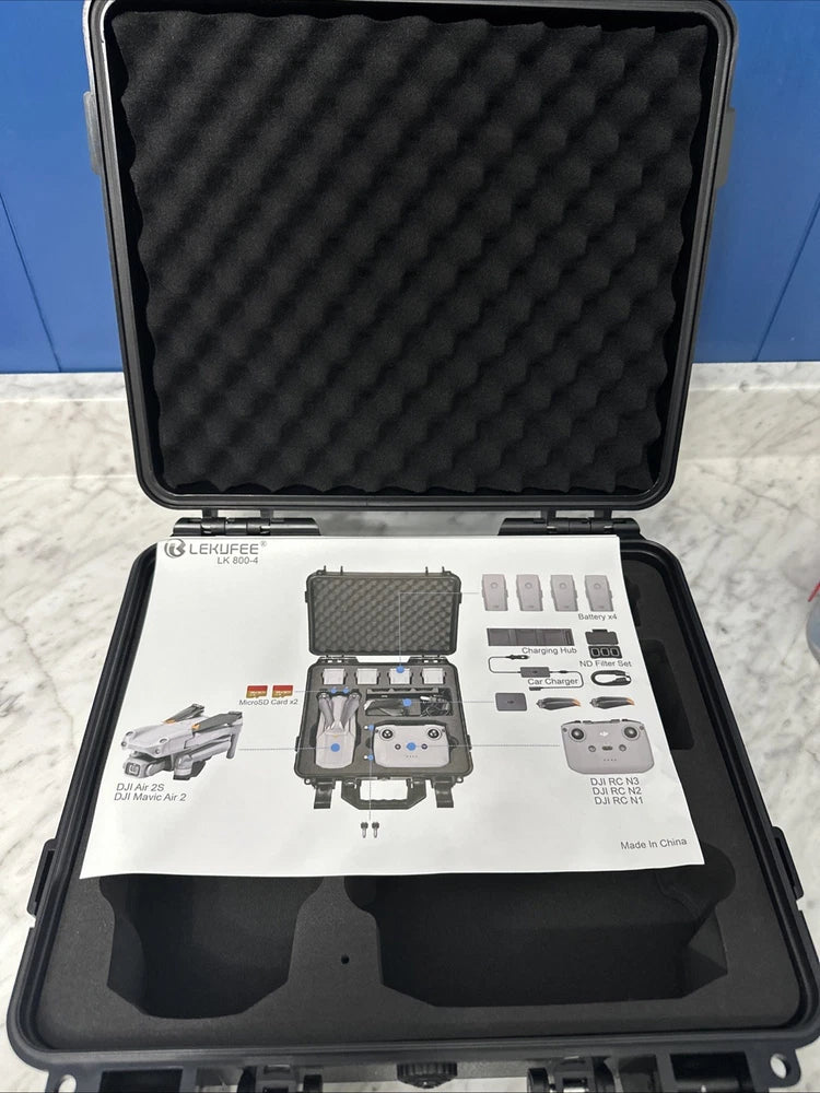 Hard-shell drone carrying case with foam insert and accessory compartments, open view