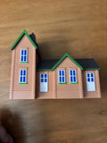 TrackMaster station building model with green roof and blue window details