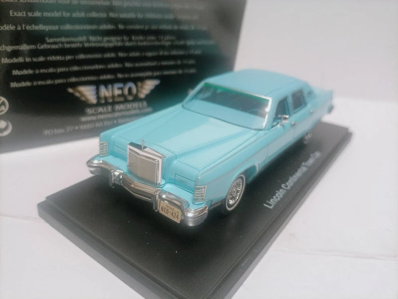 Neo 1:43 Lincoln Town Car die-cast model, light blue 1978 sedan front 3/4 view