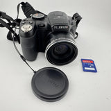 FUJIFILM digital camera with lens, front cap, strap, and 4GB SD card
