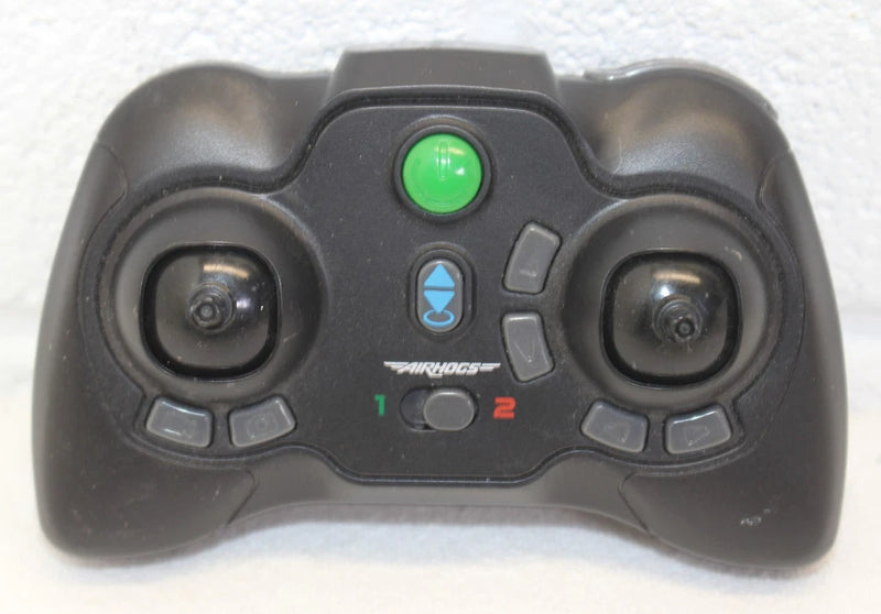 Black Air Hogs remote controller with dual joysticks, green power button, blue mode light