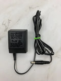 General Electric AC/DC power converter with label, black box and barrel plug power cord